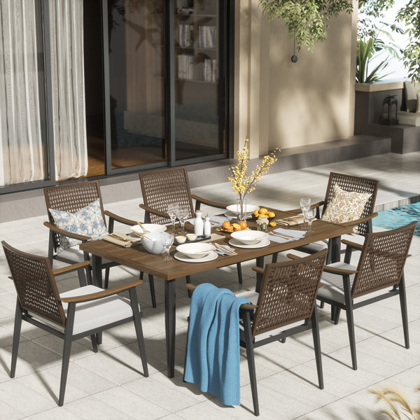 Bayou Breeze Arthetta 7 Piece Outdoor Dining Table Set with 6 Rattan Wicker Chairs with Cushions Reviews Wayfair